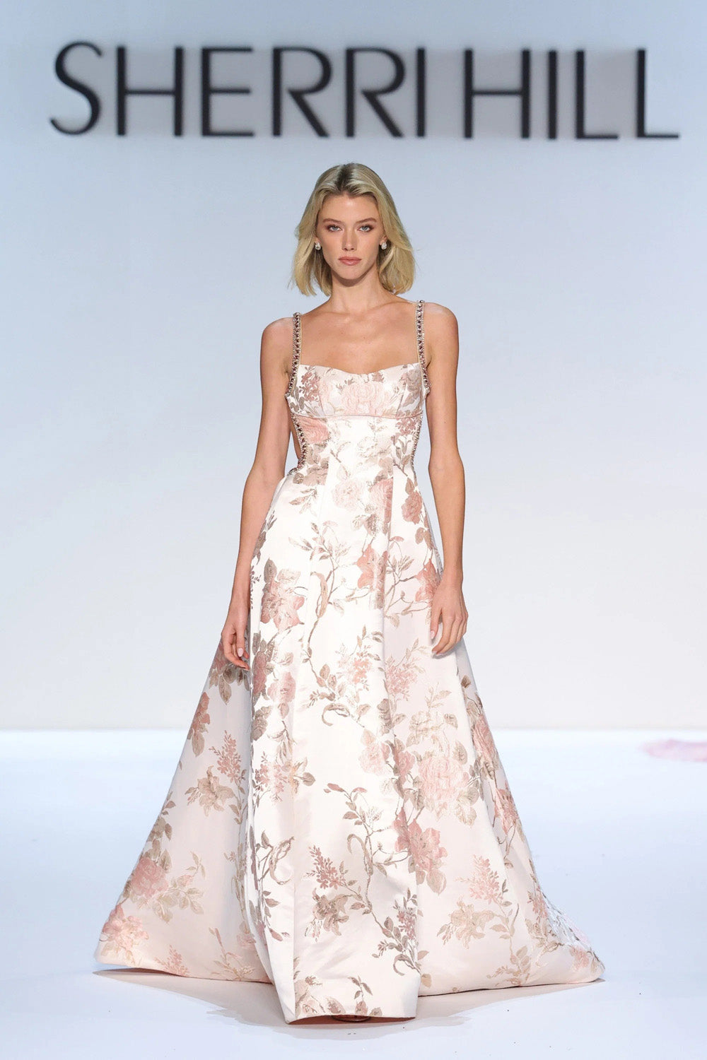 Sherri Hill 58729 blush print floral brocade A-line gown full length front view on runway