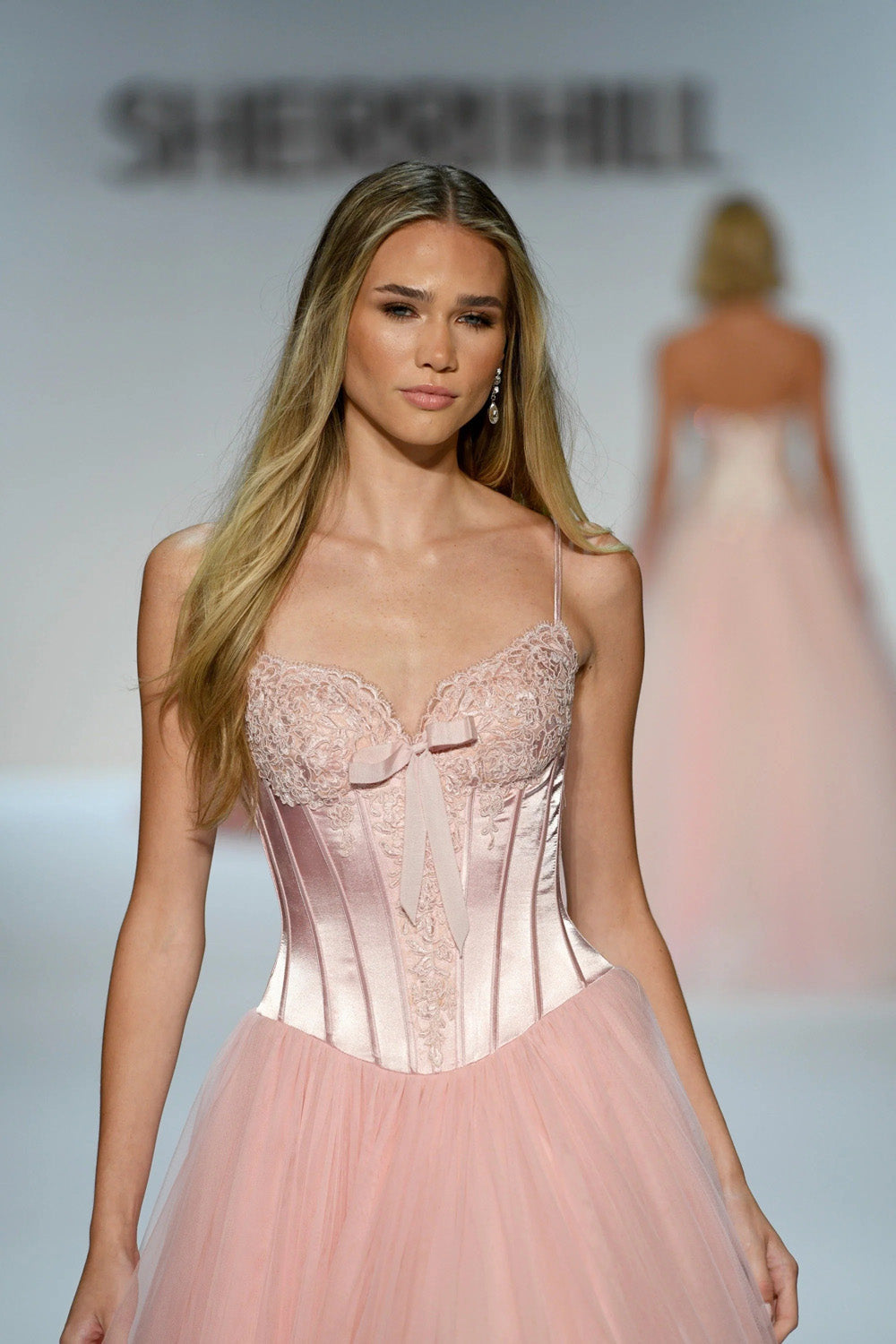 Close up of Sherri Hill 58736 rose satin corset bodice with lace trim and satin bow detail
