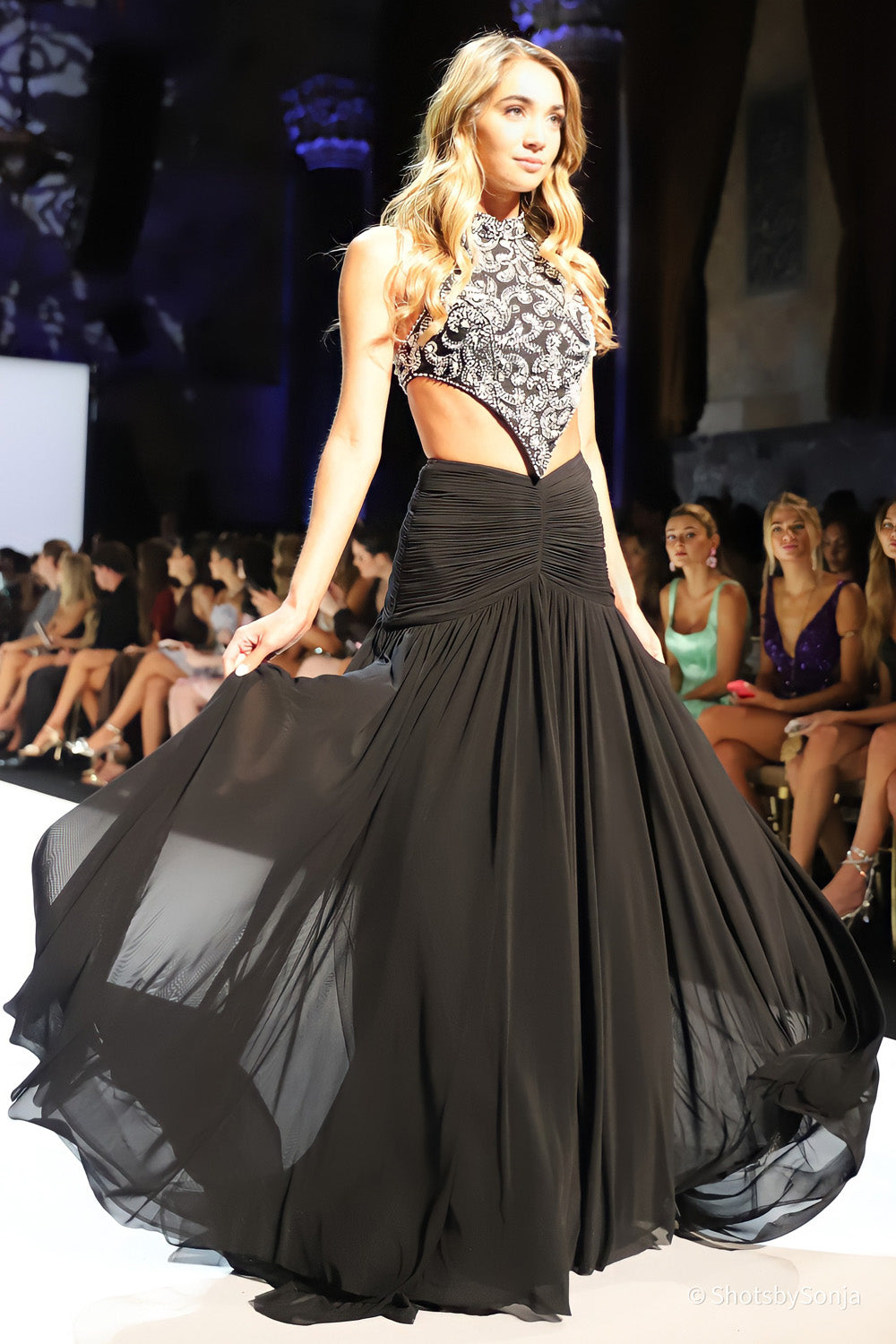 Sherri Hill 58832 black silver full length gown with beaded halter bodice and flowing chiffon skirt in motion