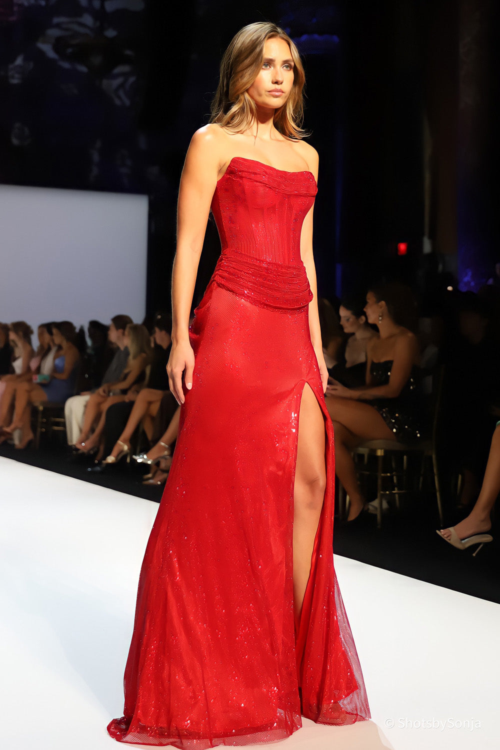 Sherri Hill 58899 red embellished corset dress with ruched waist and high front slit floor length skirt side view