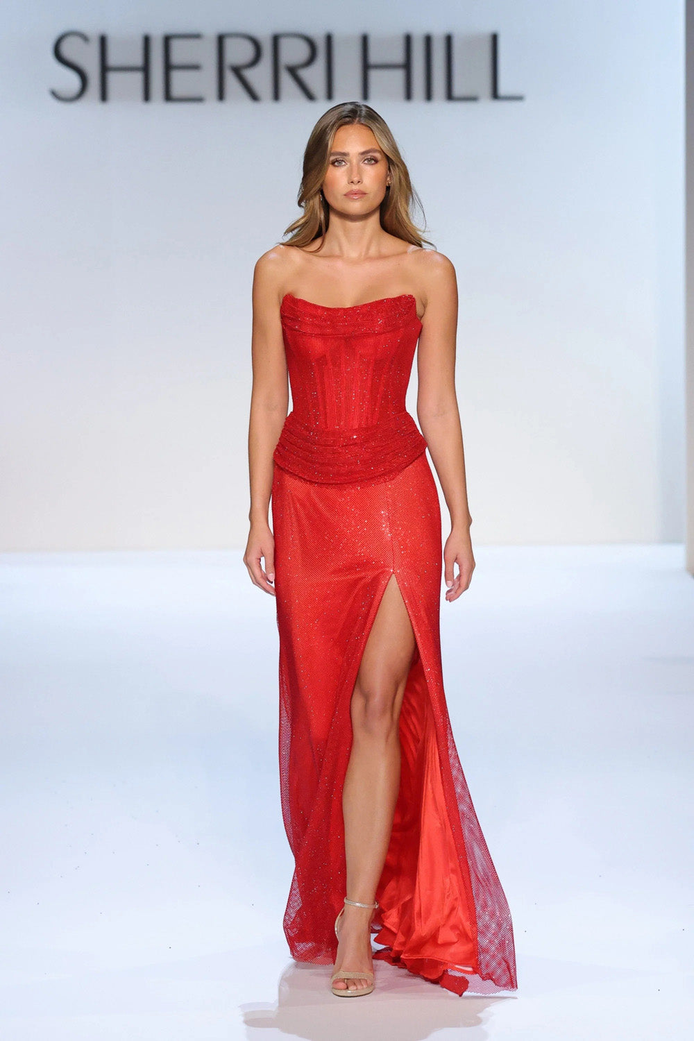Sherri Hill 58899 red strapless beaded corset gown with draped bustline ruched waist and flowing front slit skirt