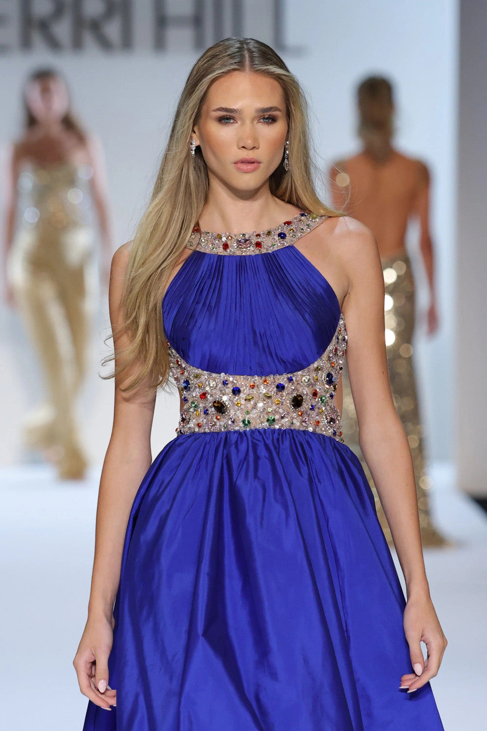 Sherri Hill 58905 bright royal blue halter bodice close up showing dense multicolor stone embellishment at neckline and waistband