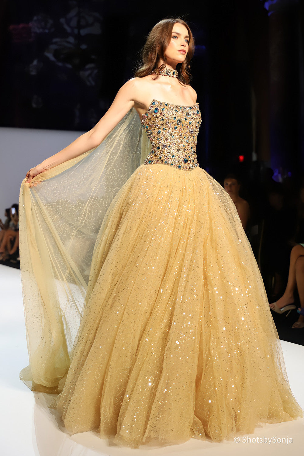 Sherri Hill 58932 nude gold multi ballgown with embroidered sheer cape floating from shoulder side view