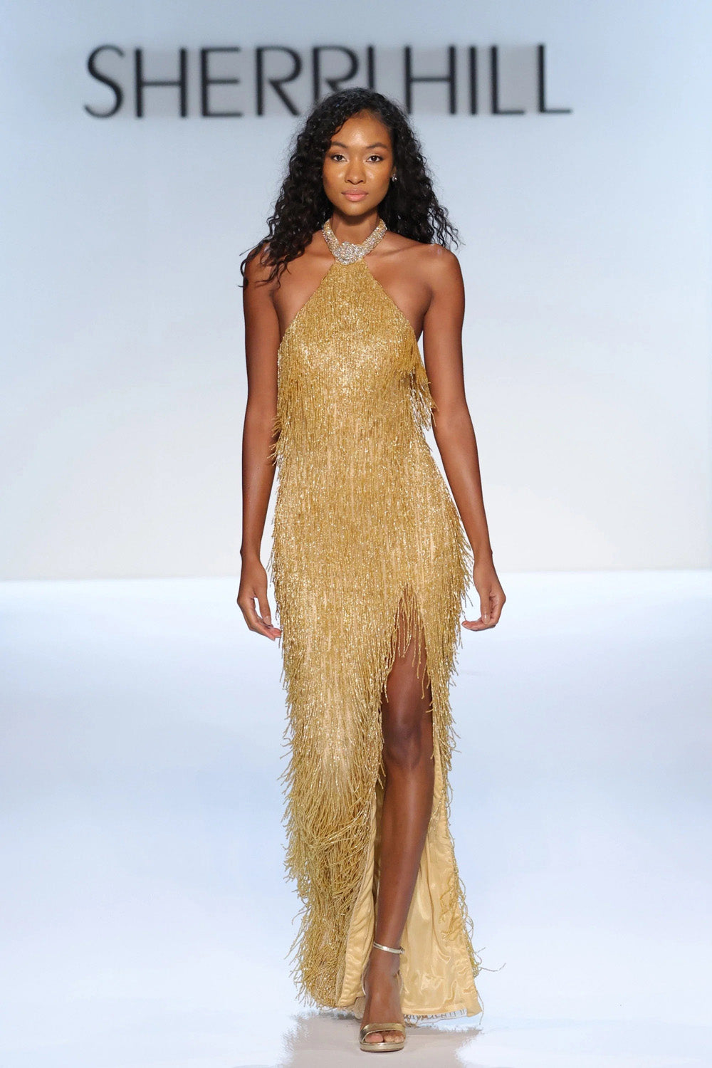 Sherri Hill 67331 nude gold AB silver beaded fringe halter gown front view on bright runway background
