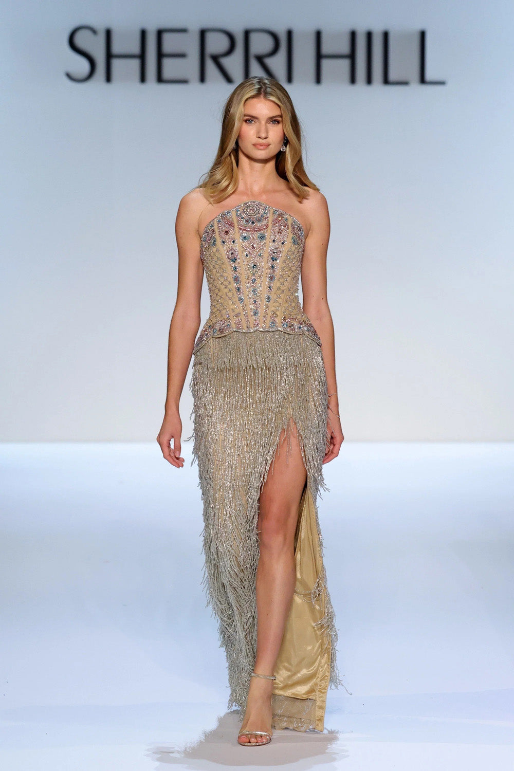 Sherri Hill 67341 nude silver strapless beaded corset dress with cascading metallic fringe skirt and champagne satin underlay