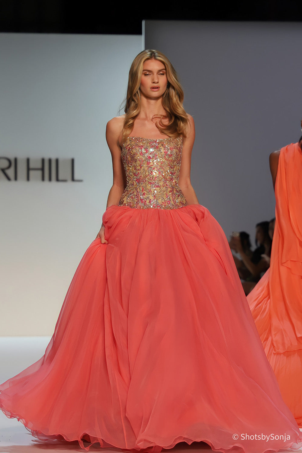 Sherri Hill 67344 coral ballgown with gold and pink beaded bodice and full flowing coral skirt front view