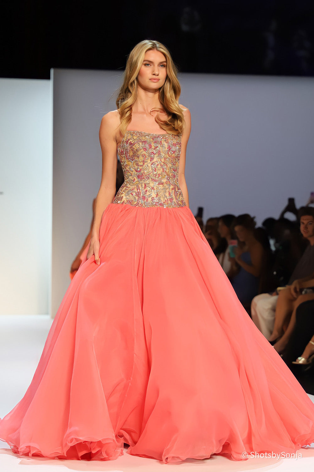 Sherri Hill 67344 coral ballgown full length front view with heavily beaded gold bodice and soft sweeping skirt