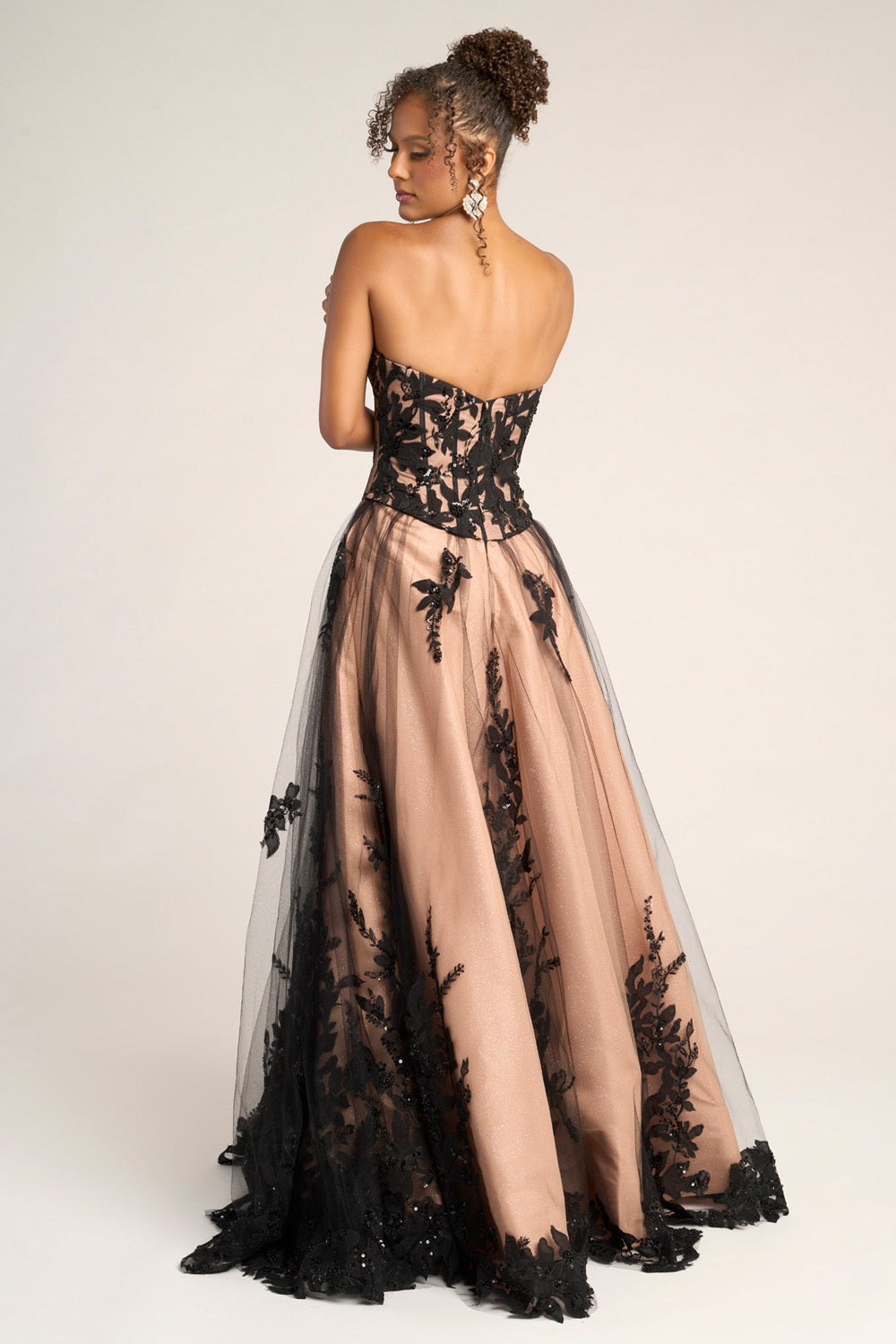 Portia and Scarlett PS26061 Black and nude prom dress with a fitted bodice and floral lace detailing, back view.