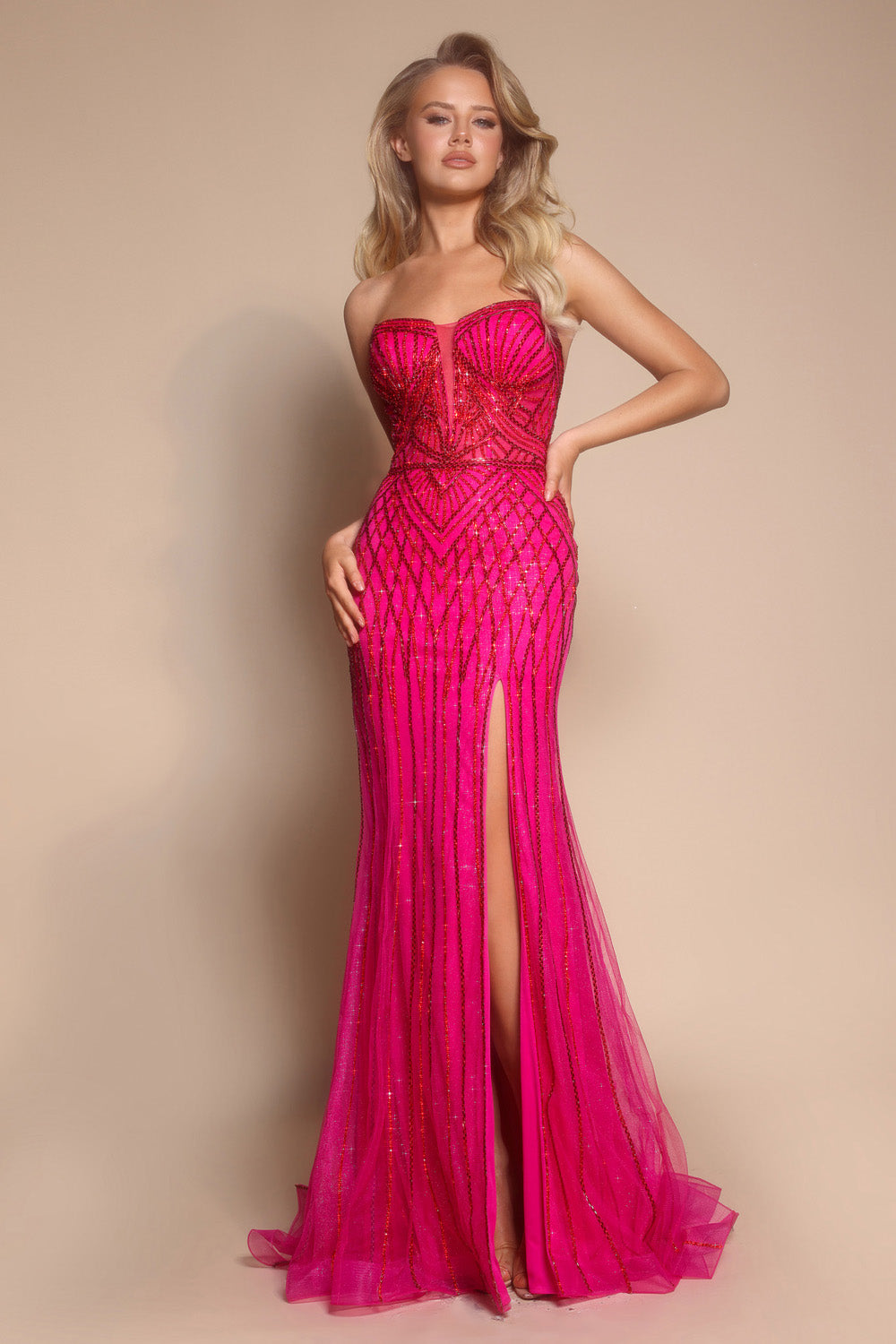 Portia and Scarlett PS26072 Fuchsia mermaid prom dress with a thigh-high slit and intricate beading details.