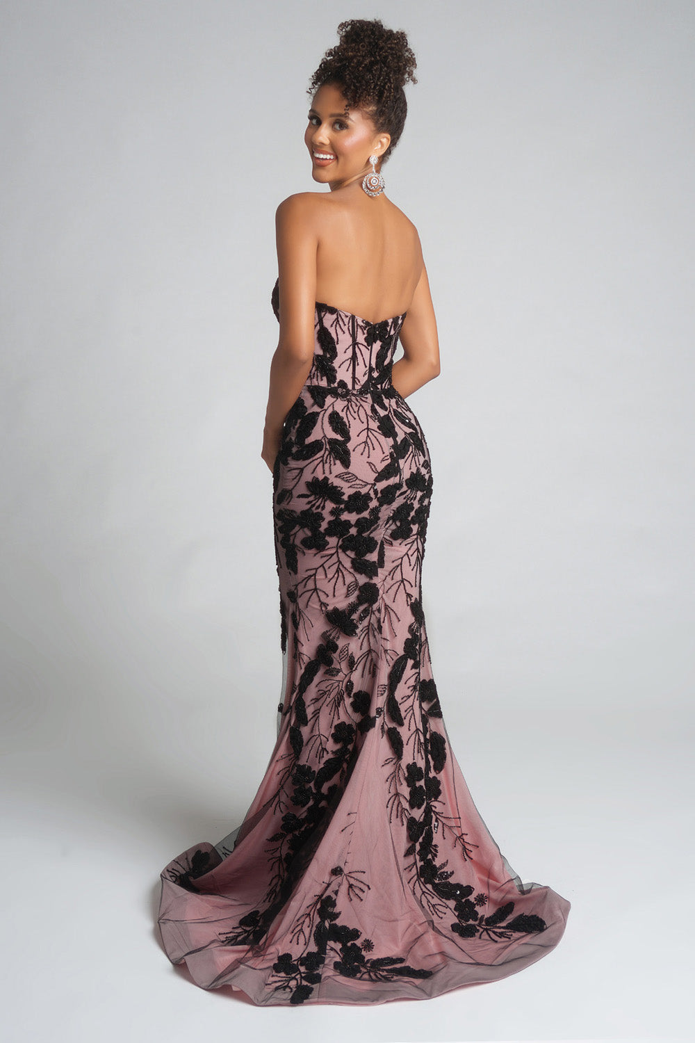 Portia and Scarlett PS26074 Fitted pink prom dress with black floral embroidery and a dramatic mermaid silhouette.