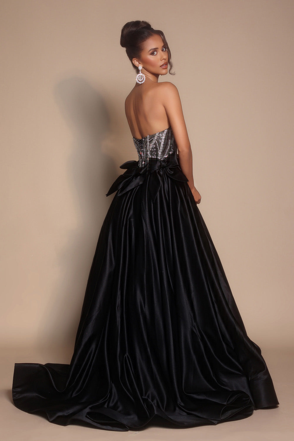 Portia and Scarlett PS26077 Black mermaid prom dress with sequined bodice and elegant bow detail at the back.