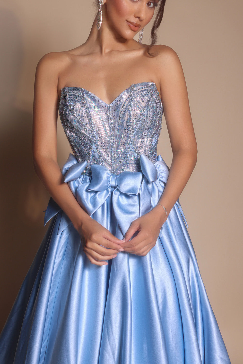 Portia and Scarlett PS26077 Strapless ocean prom dress with beaded bodice and bow detail at waist.
