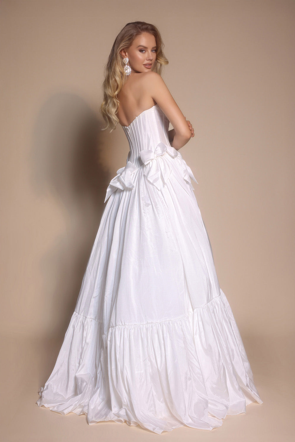 Portia and Scarlett PS26148 White ballgown prom dress with a corset back and elegant bow details.