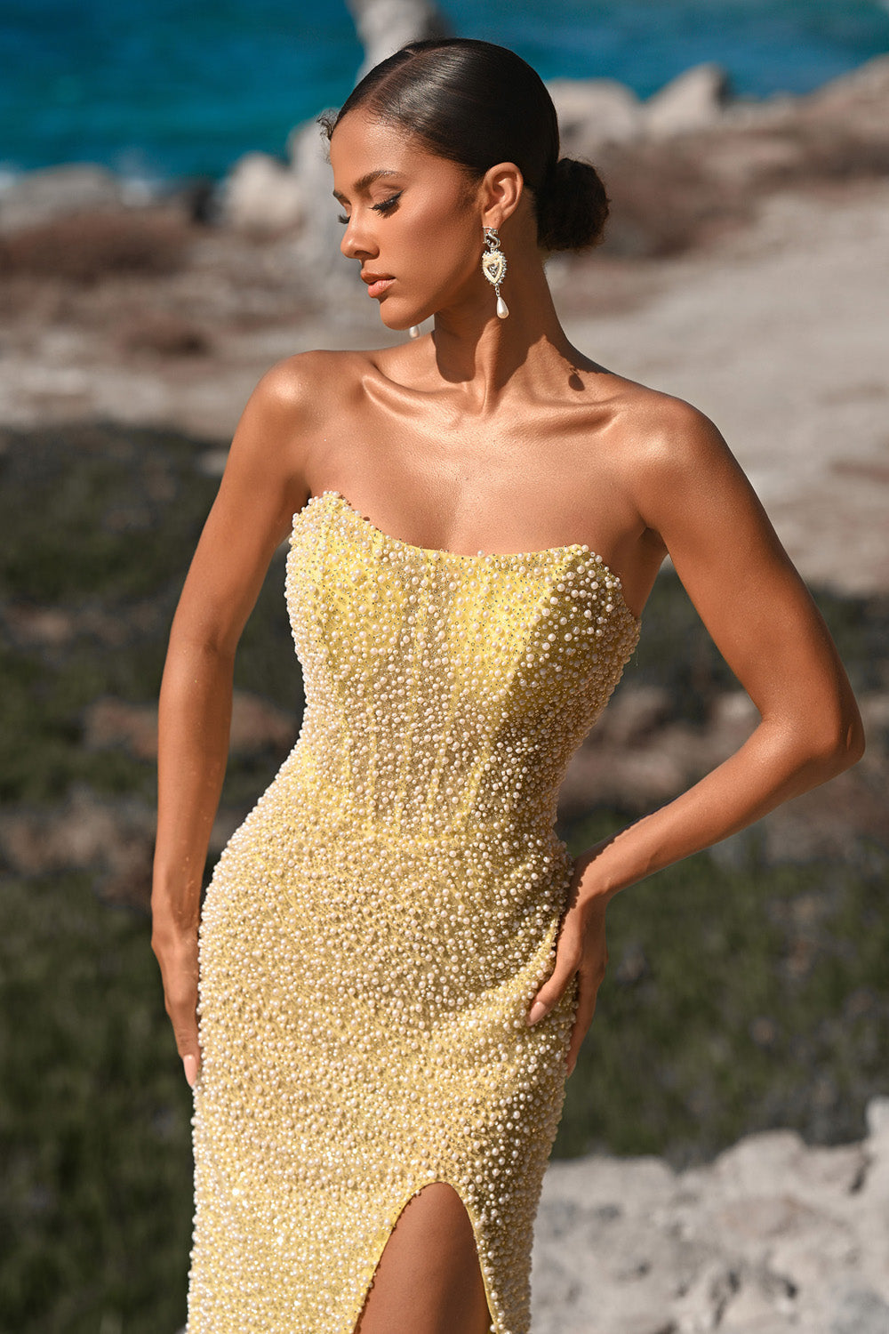 Portia and Scarlett PS26173 Yellow mermaid prom dress with beading and a thigh-high slit, front view.