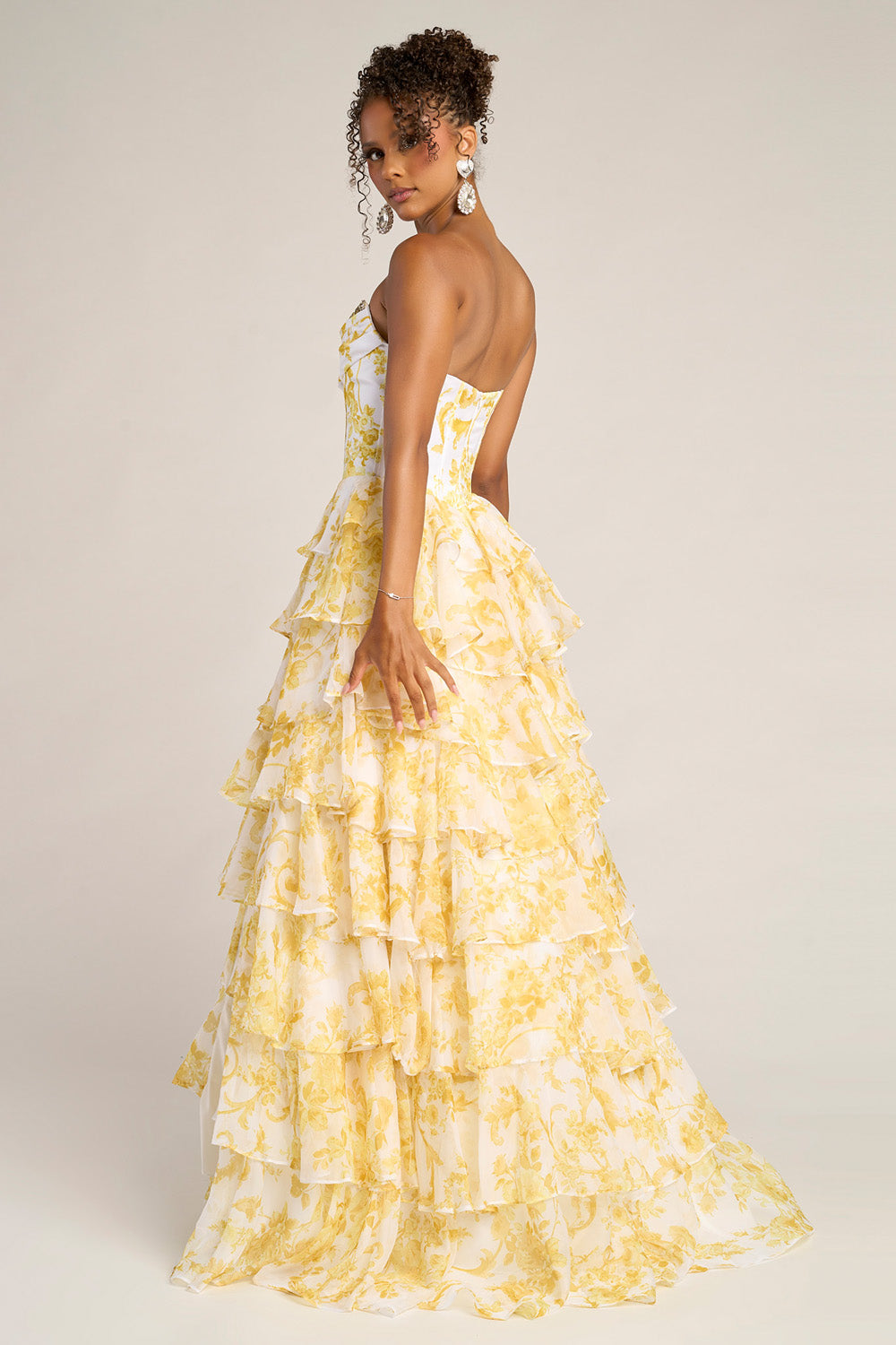 Portia and Scarlett PS26210 Yellow tiered prom dress with a fitted bodice and ruffled skirt, back view.