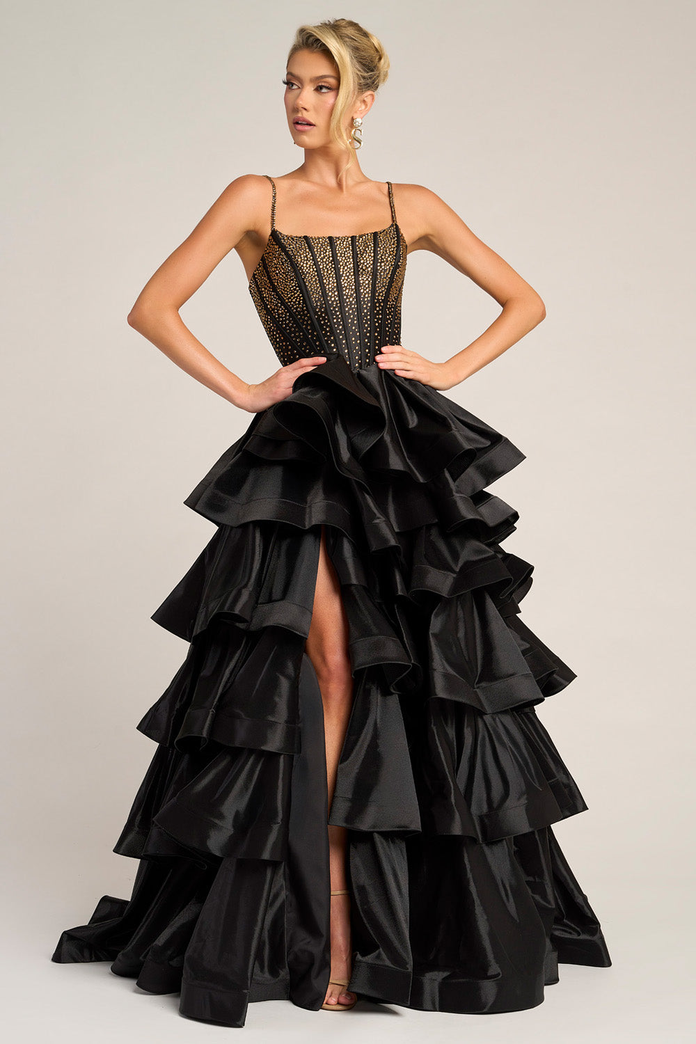 Portia and Scarlett PS26253 Black and gold mermaid prom dress with a high slit and ruffled skirt.