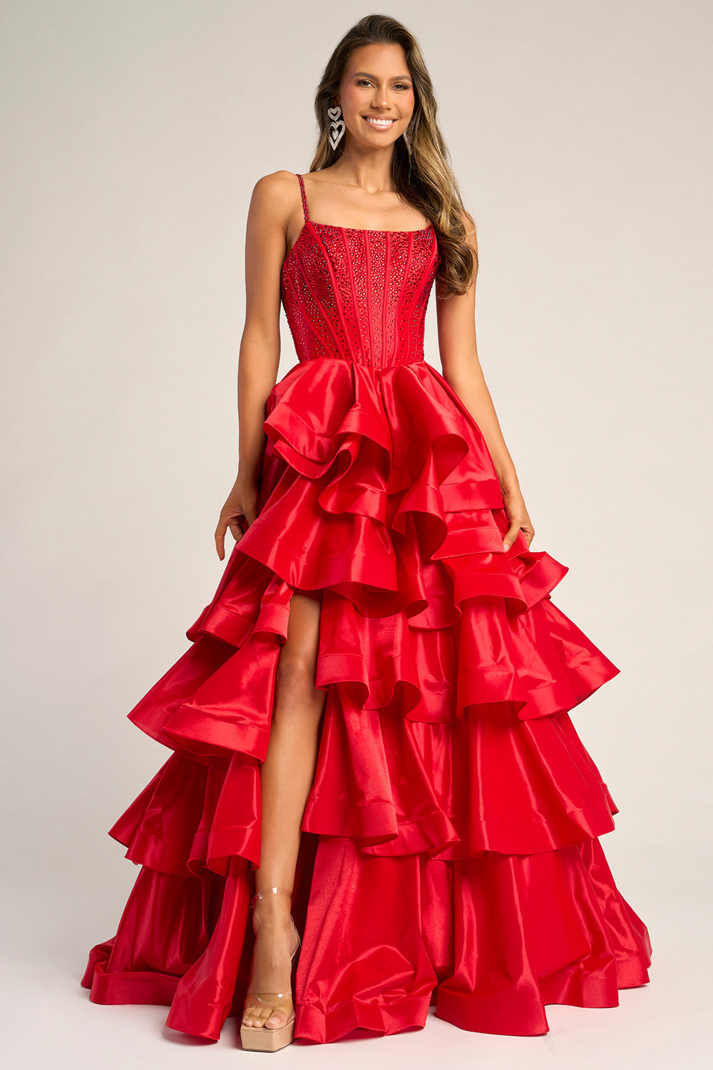 Portia and Scarlett PS26253 Red mermaid prom dress with ruffled layers and a thigh-high slit.
