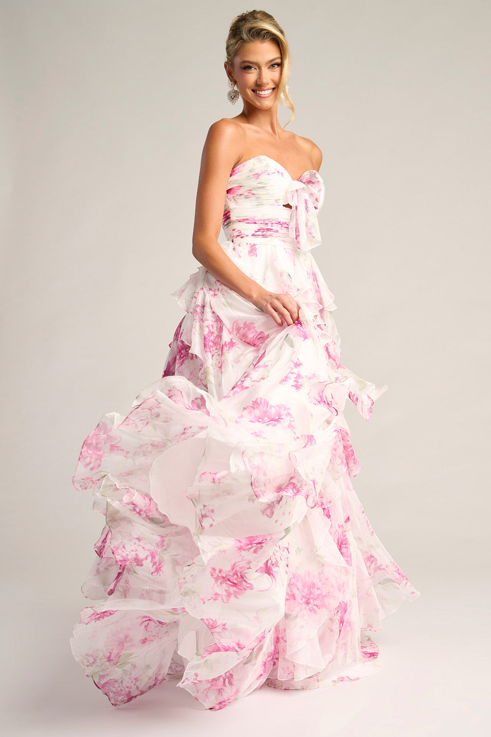 Portia and Scarlett PS26254 Strapless white and pink prom dress with ruffles and a flowing silhouette.