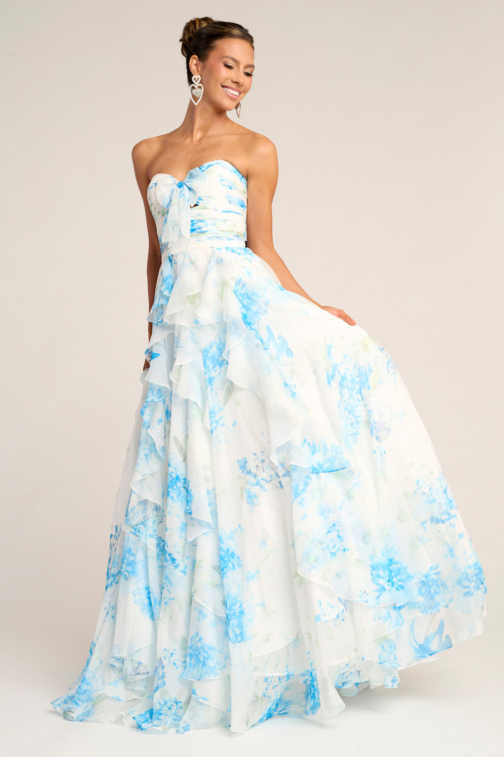 Portia and Scarlett PS26254 Strapless white and blue floral prom dress with layered ruffles and a flowing silhouette.