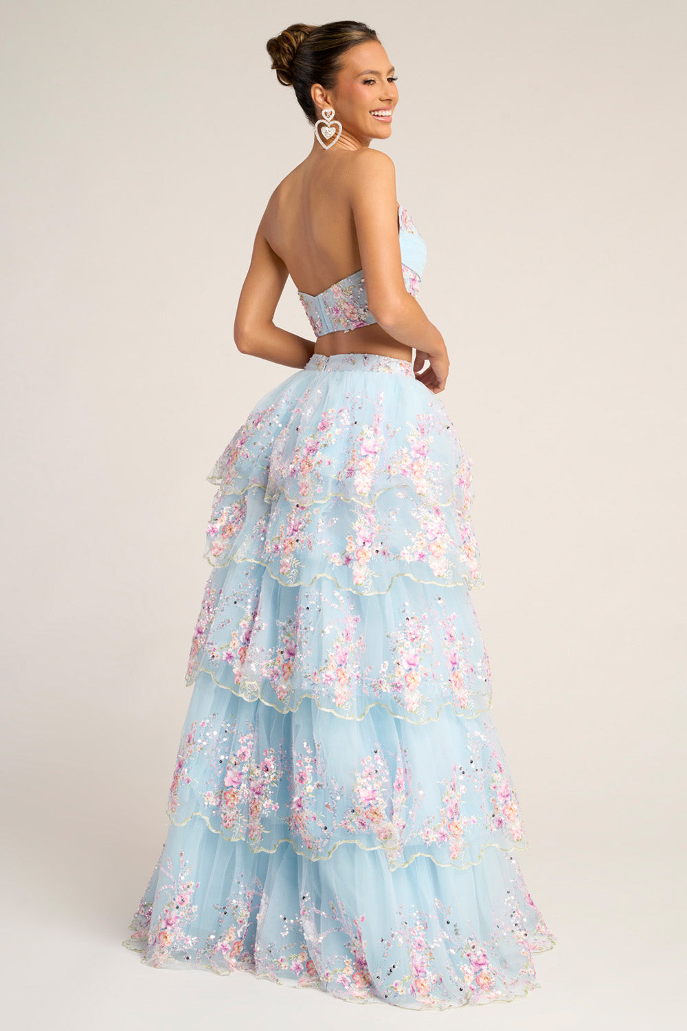 Portia and Scarlett PS26272 Blue tiered prom dress with floral embellishments and a backless design.
