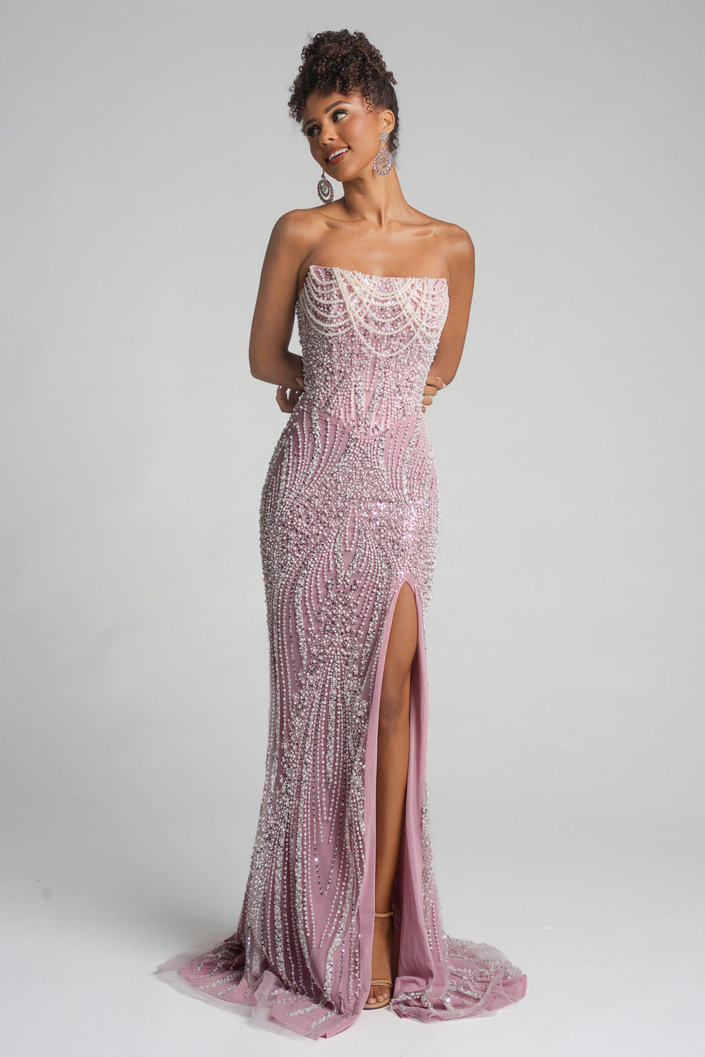 Portia and Scarlett PS26277 Strapless pink prom dress with a mermaid silhouette and side slit detail.