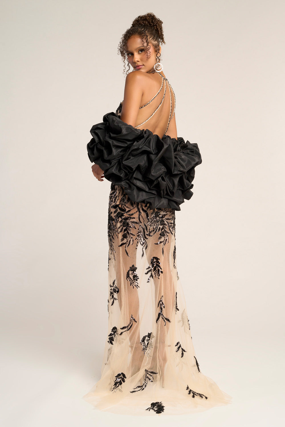 Portia and Scarlett PS26319e Black and nude mermaid prom dress with a dramatic ruffled back and intricate beading.