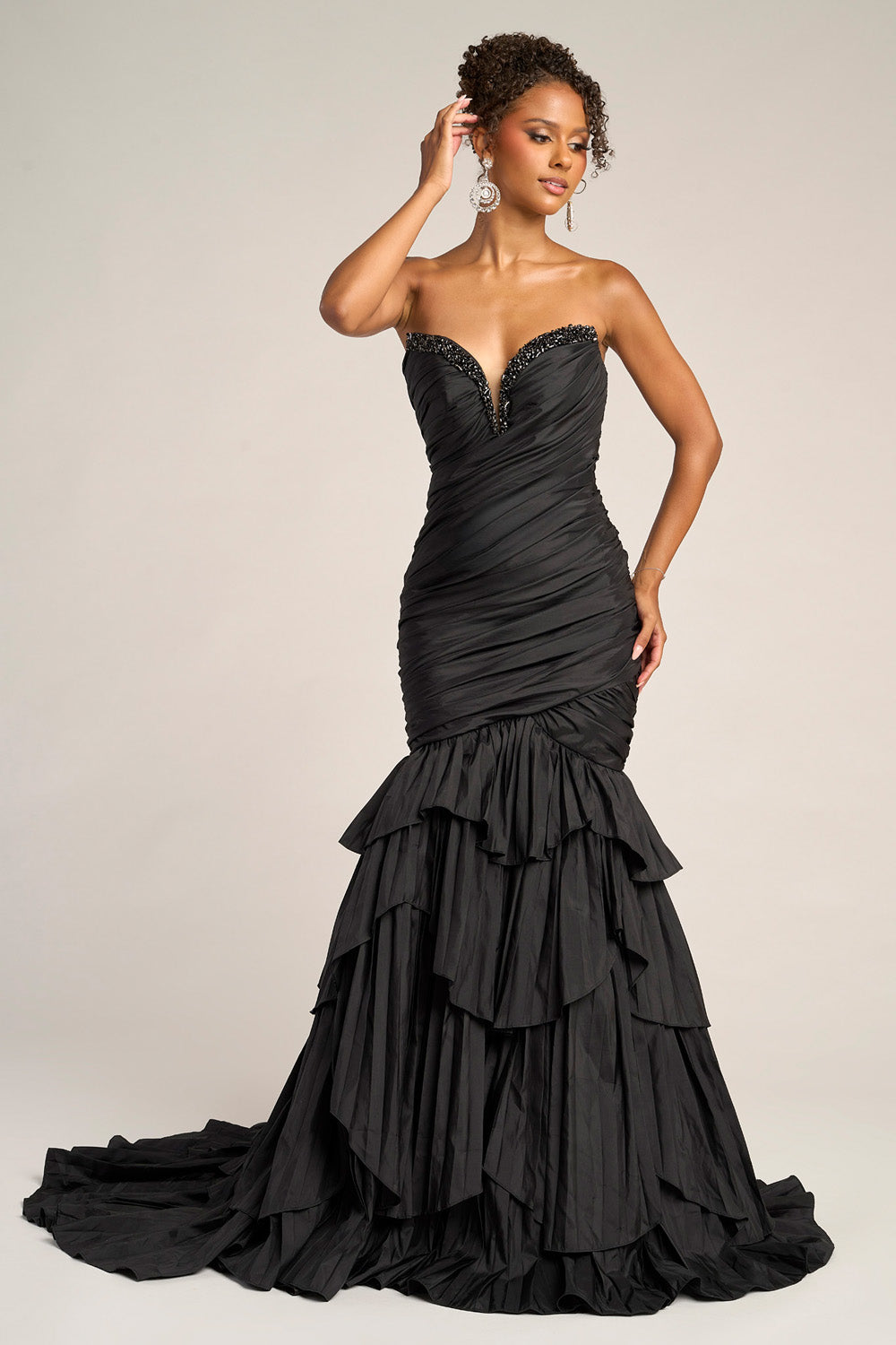 Portia and Scarlett PS26325e Black mermaid prom dress with ruffled layers and a plunging neckline.