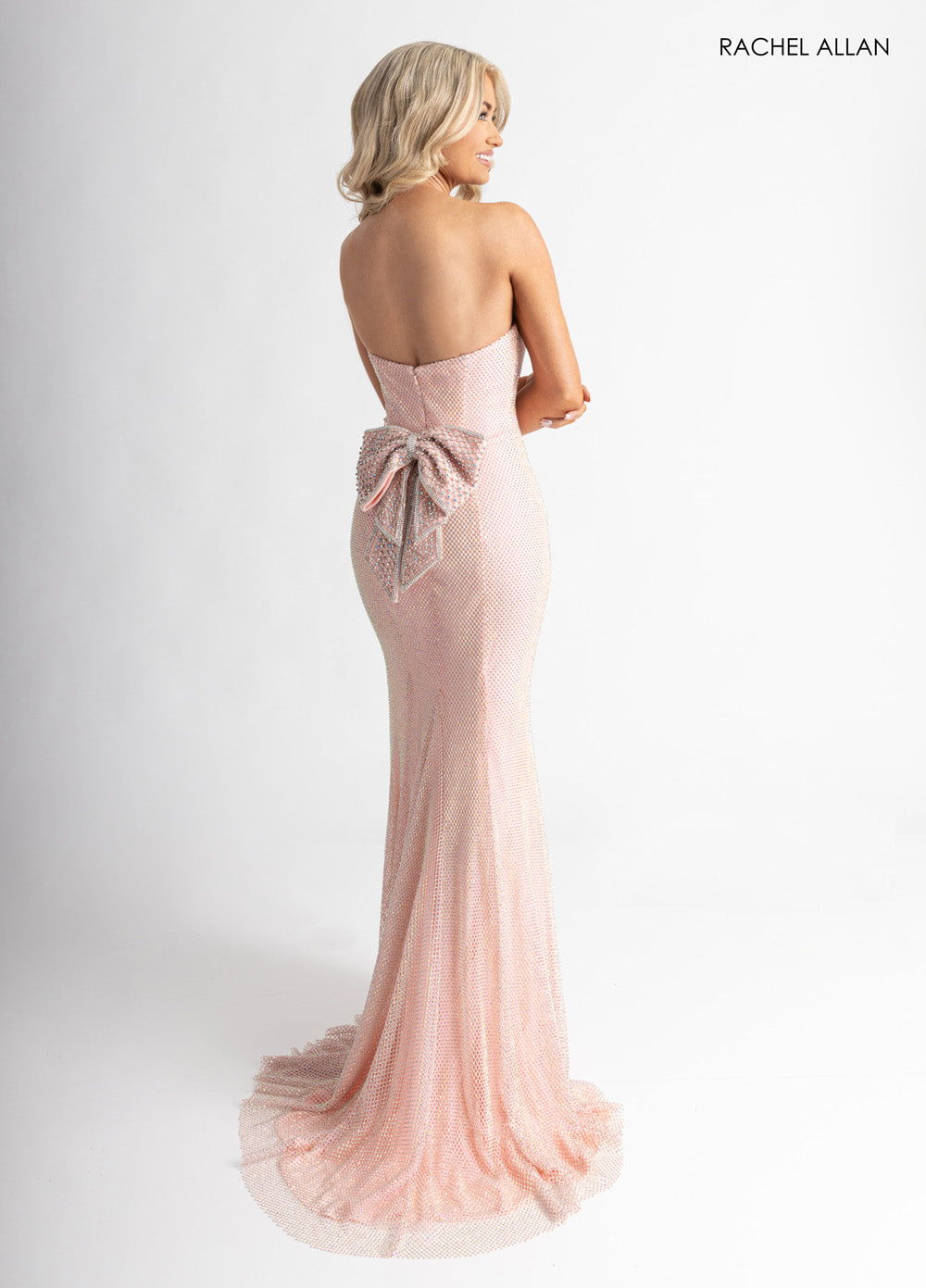 Rachel Allan 70936 Blush mermaid prom dress with crystal beading and a bow detail at the back.
