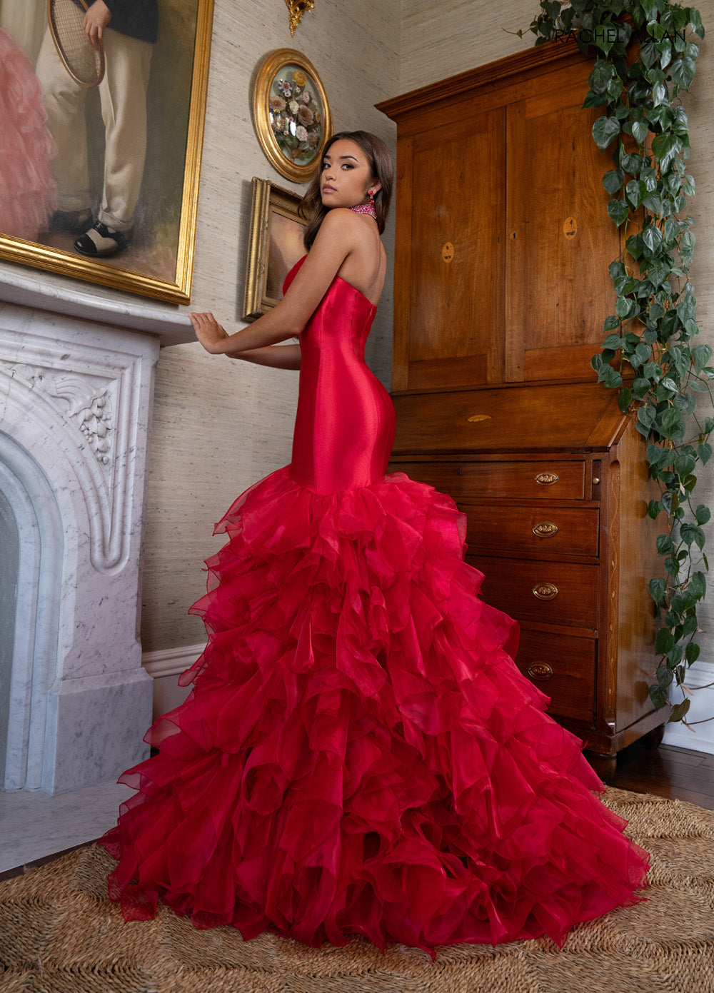 Rachel Allan 70938 Red mermaid prom dress with ruffled organza skirt and crystal beading, side view.