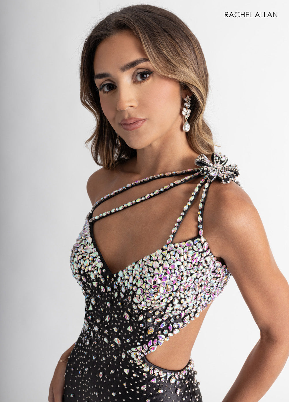 Rachel Allan 70943 Black fitted prom dress with crystal beading and unique shoulder detail.