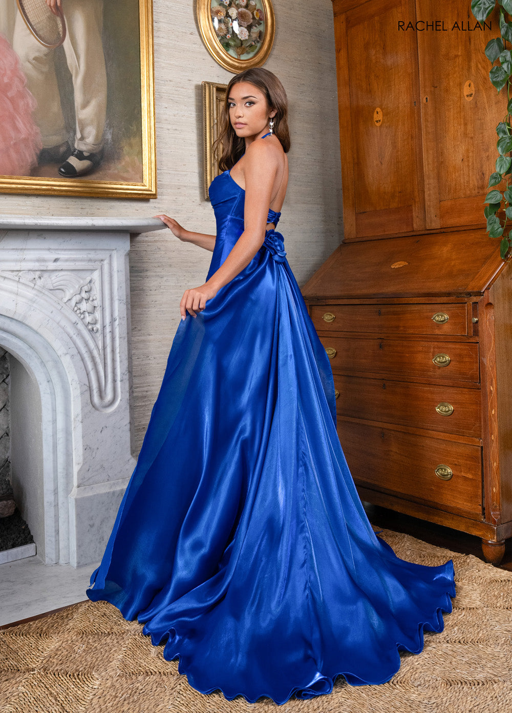 Rachel Allan 70945 Royal blue formal gown with a fitted silhouette and elegant bow detail at the back.