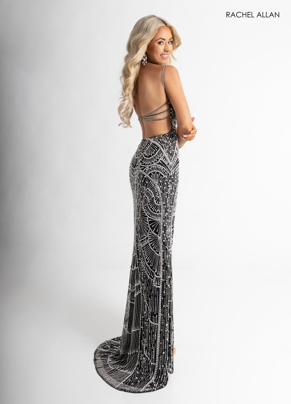Rachel Allan 70970 Black mermaid prom dress with pearl beading and lace-up back, side view.