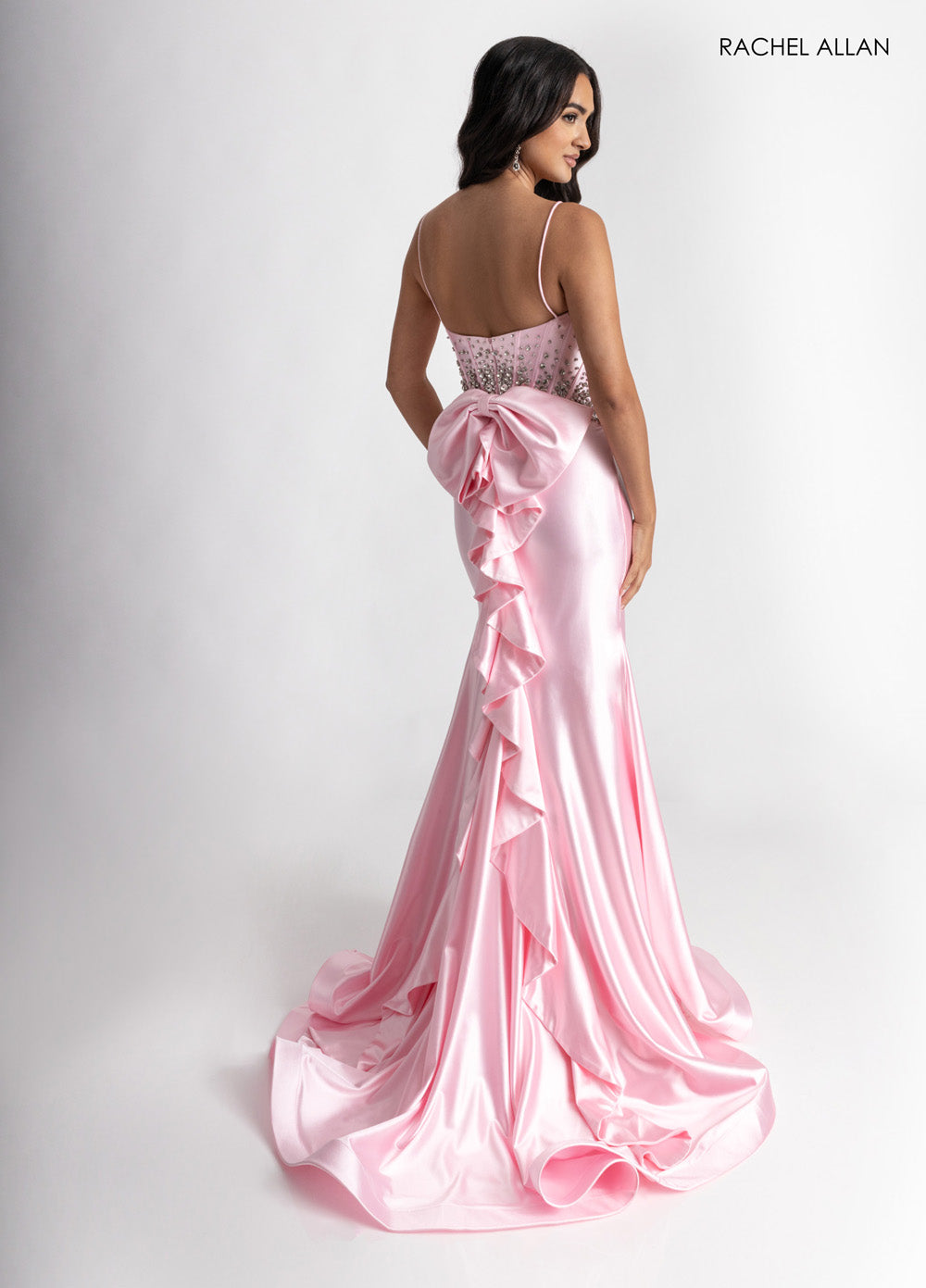 Rachel Allan 70971 Pink mermaid prom dress with crystal beading and a dramatic bow detail.