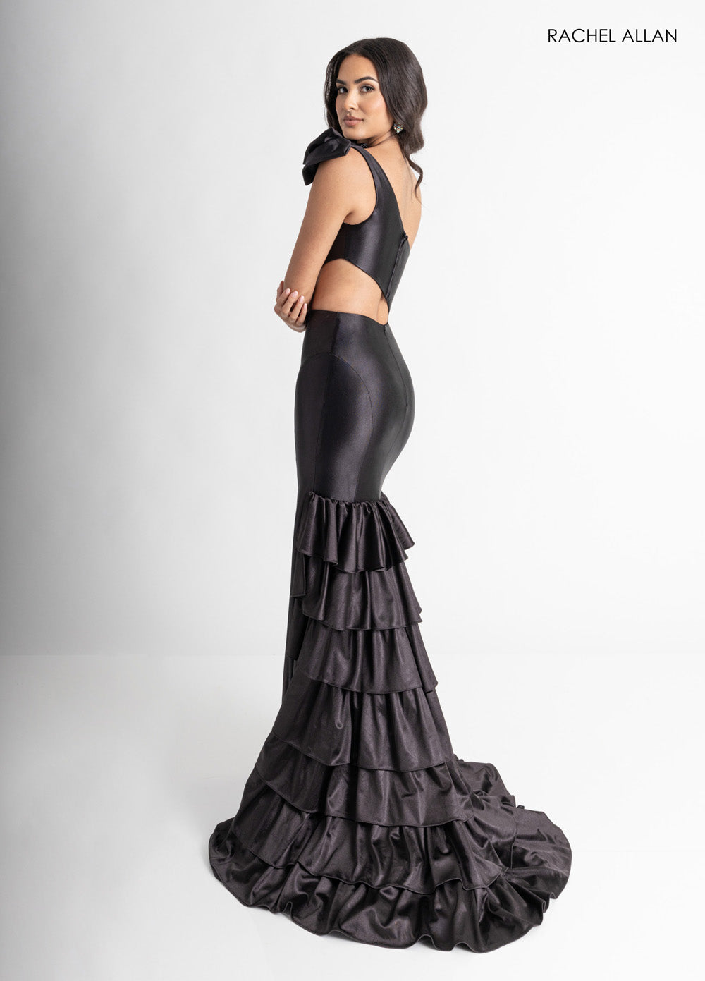 Rachel Allan 70976 Black mermaid prom dress with a corset bodice and layered ruffle train.