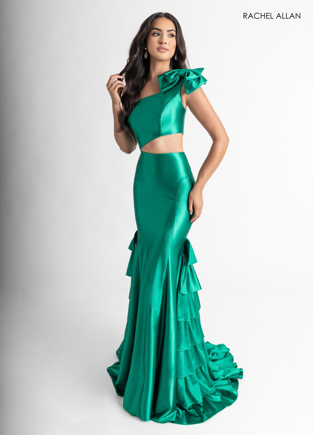 Rachel Allan 70976 Emerald green mermaid prom dress with a corset bodice and ruffled train.