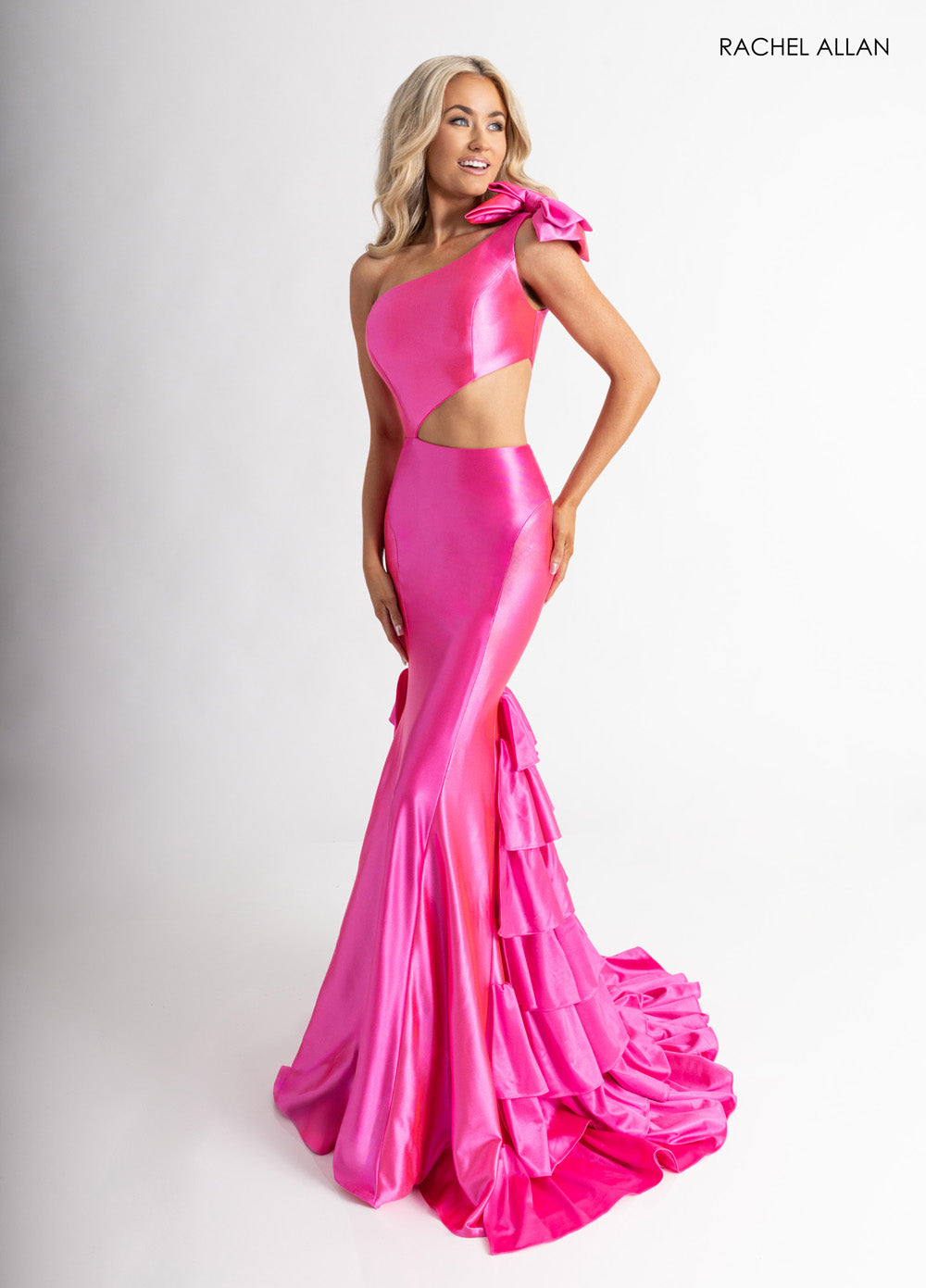 Rachel Allan 70976 Fuchsia mermaid prom dress with a dramatic ruffled train and one-shoulder design.