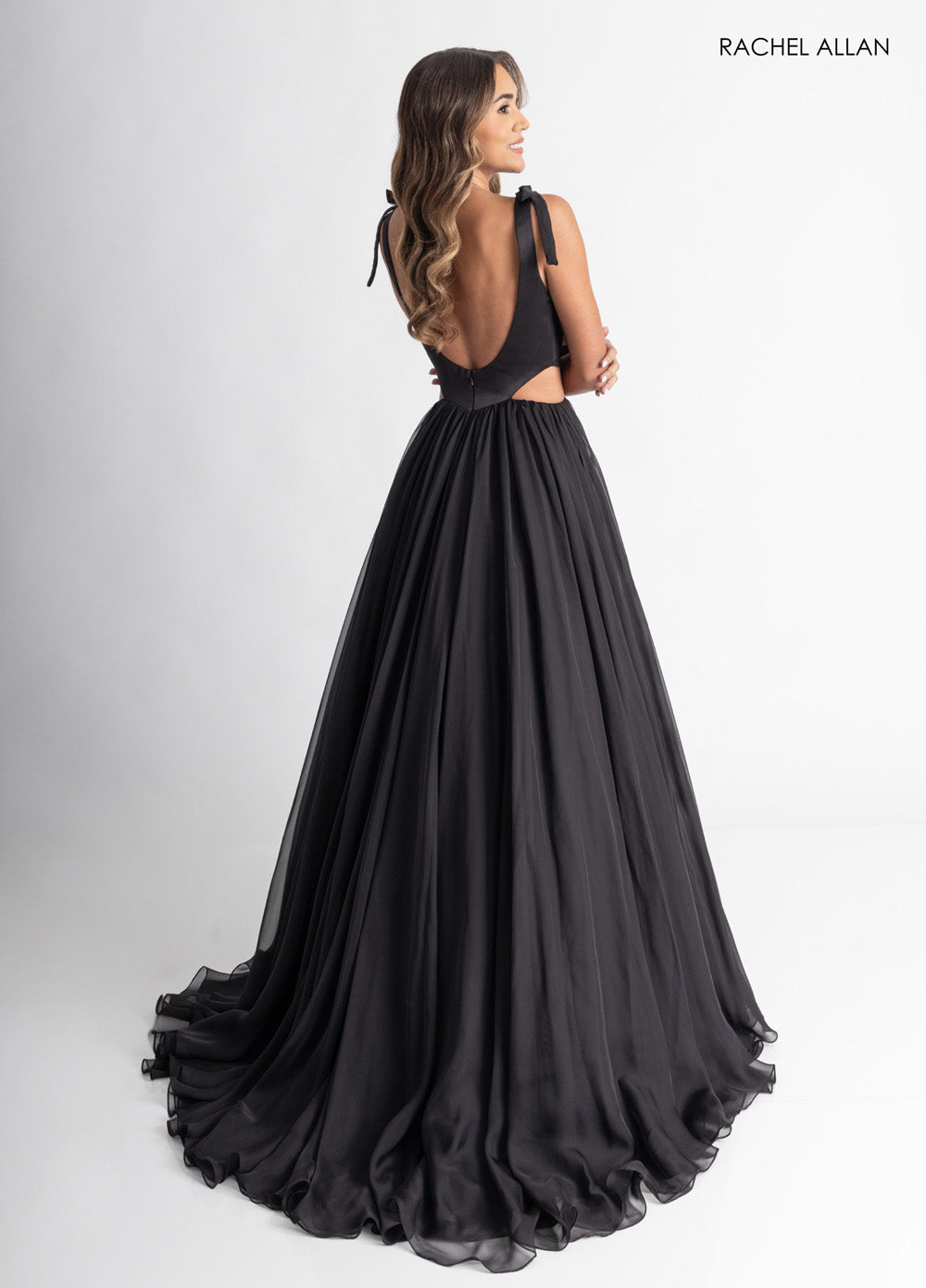 Rachel Allan 70980 Black A-line prom dress with a low back and flowing chiffon skirt.