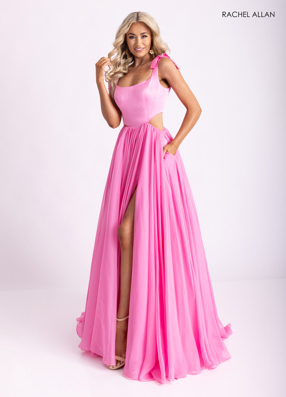 Rachel Allan 70980 Pink A-line prom dress with a high slit and shoulder ties, front view.