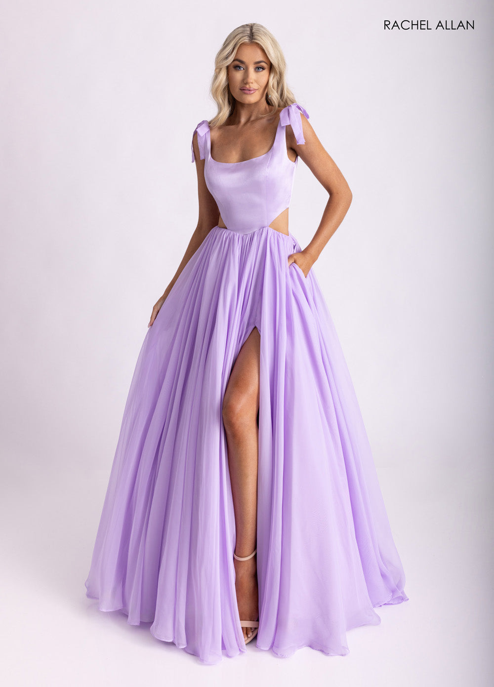 Rachel Allan 70980 Lilac A-line prom dress with a high slit and bow-tie straps, front view.