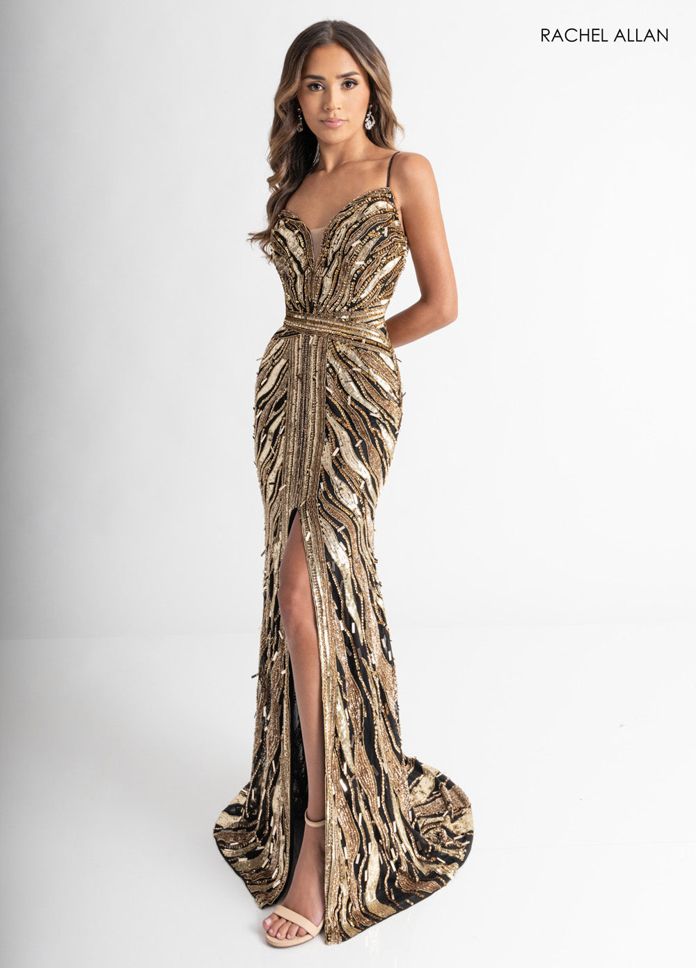 Rachel Allan 70990 Black and gold mermaid prom dress with a stunning slit and beaded corset bodice.