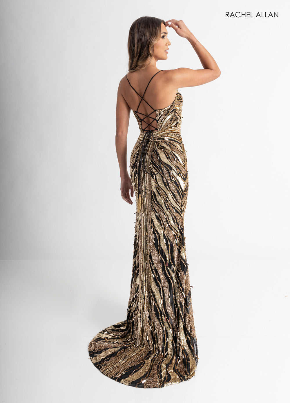 Rachel Allan 70990 Black and gold mermaid prom dress with intricate beading and a lace-up back.