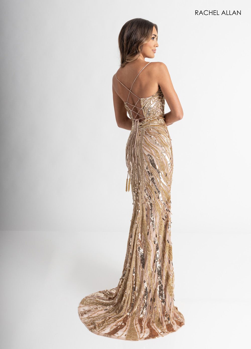 Rachel Allan 70990 Nude gold mermaid prom dress with beading and lace-up back, side view.