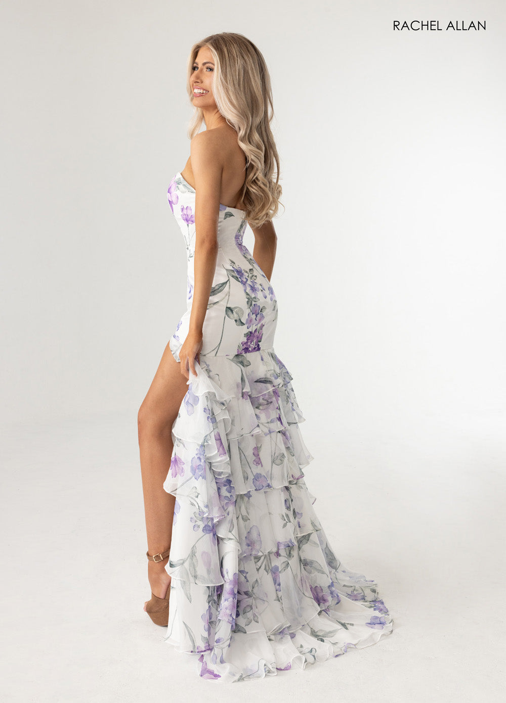 Rachel Allan 70995 Floral print formal gown in white with a corset bodice and side slit.