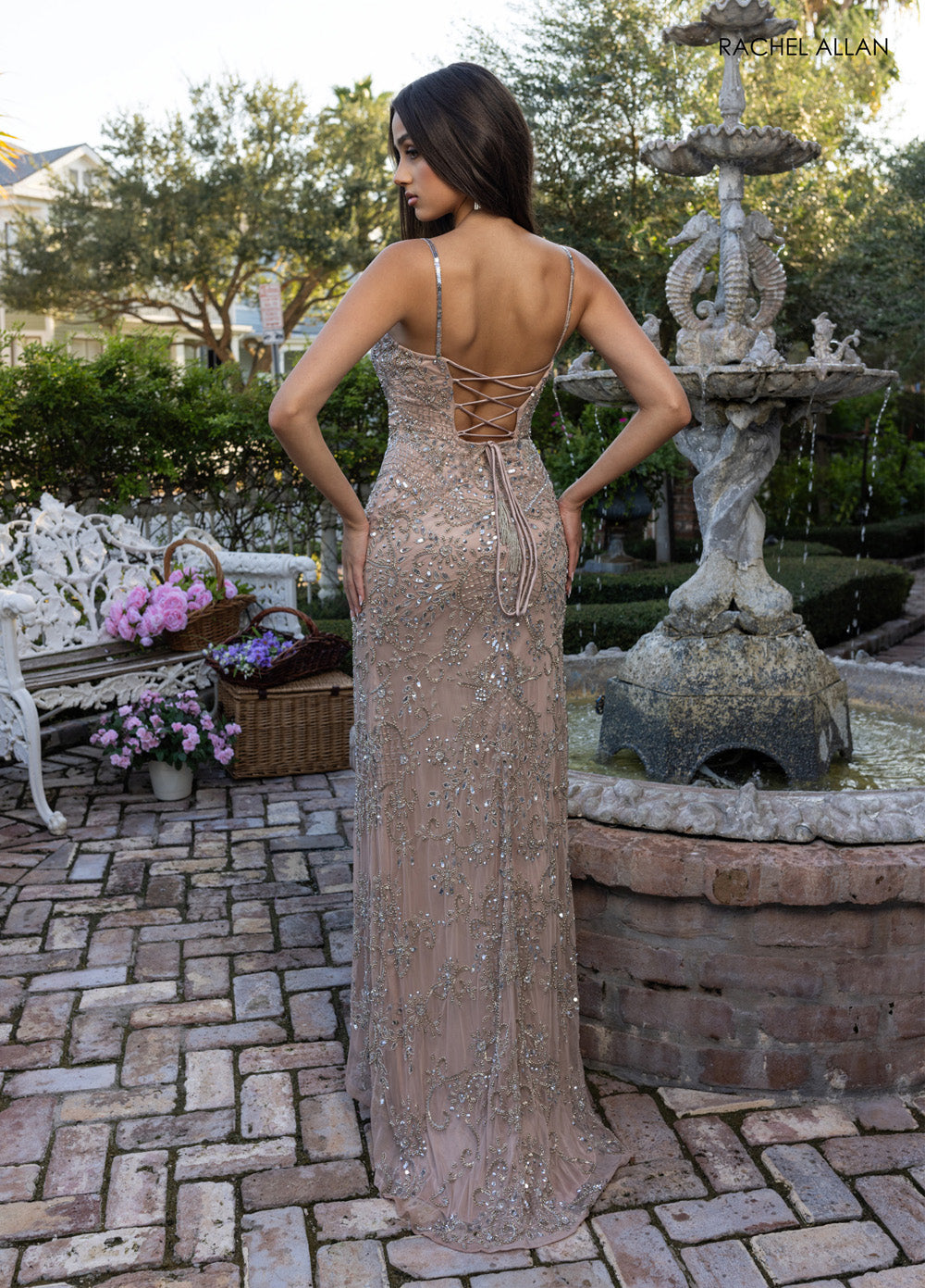 Rachel Allan 70999 Nude formal gown with intricate beading and lace-up back, side view.