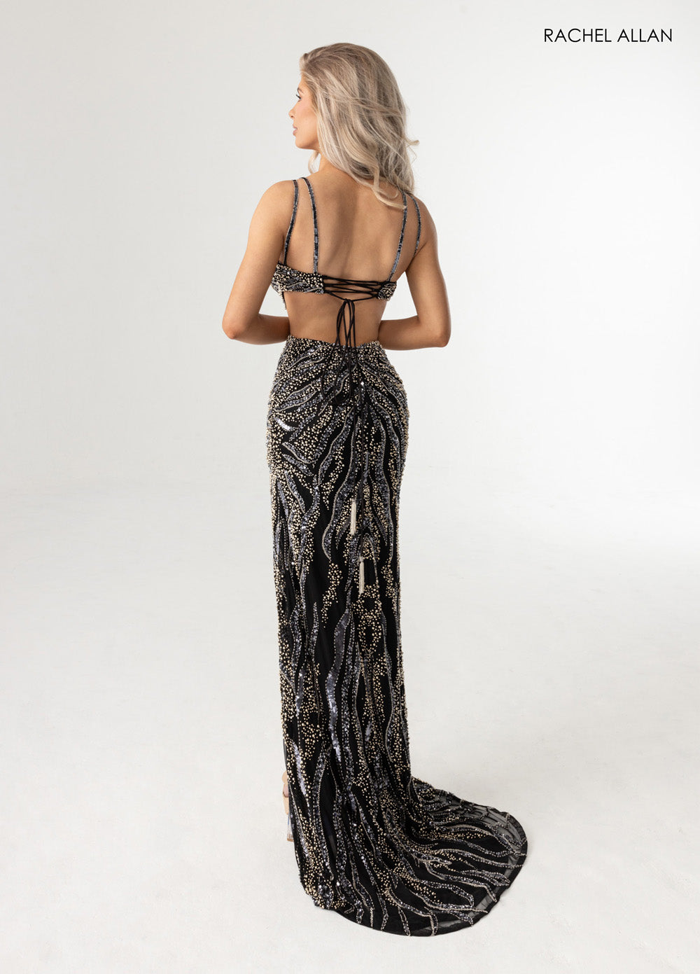 Rachel Allan 71005 Black mermaid prom dress with pearl beading and lace-up back, side view.