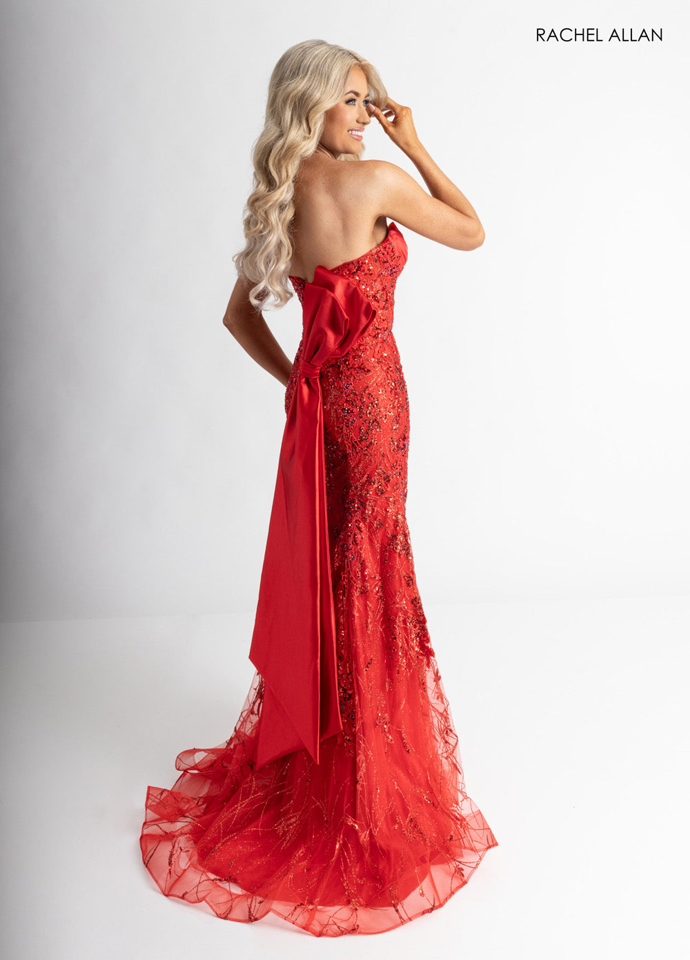 Rachel Allan 71008 Red mermaid prom dress with crystal beading and a dramatic back bow.
