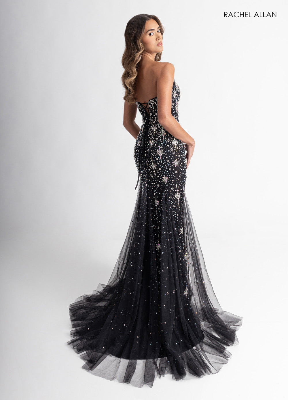 Rachel Allan 71013 Black mermaid prom dress with crystal beading and lace-up back, back view.