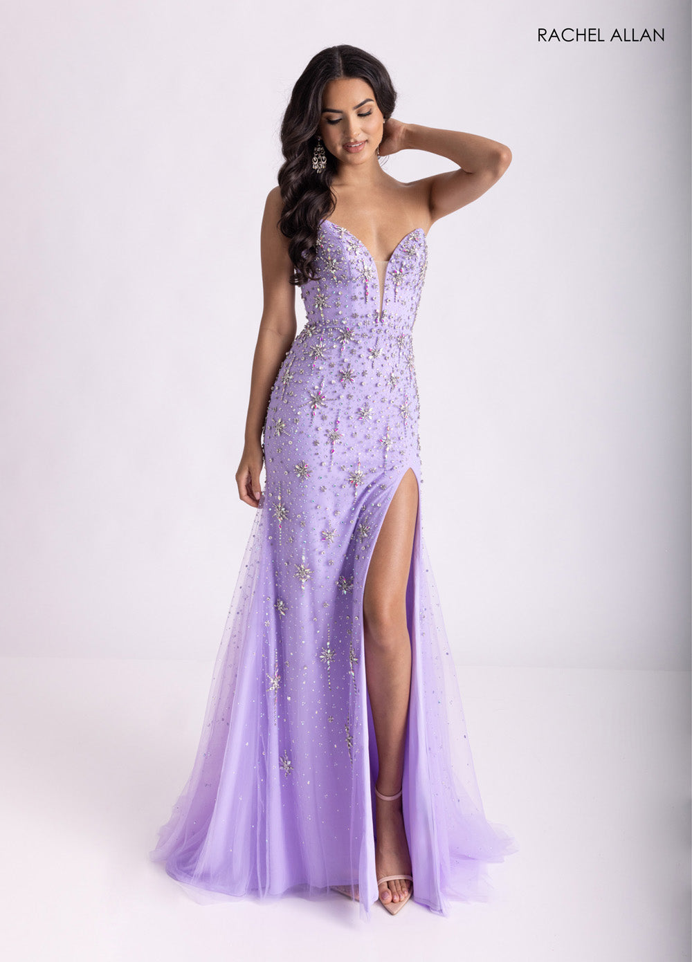 Rachel Allan 71013 Lilac prom dress with a fitted silhouette and crystal beading, featuring a thigh-high slit.