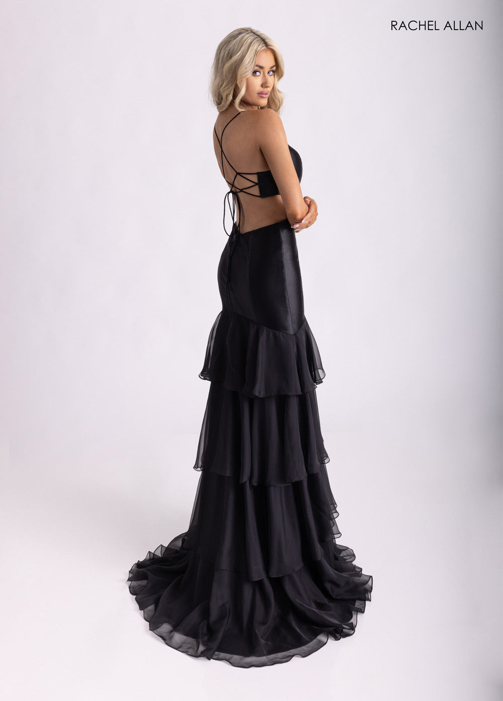 Rachel Allan 71027 Black mermaid prom dress with layered chiffon ruffles and lace-up back detail.