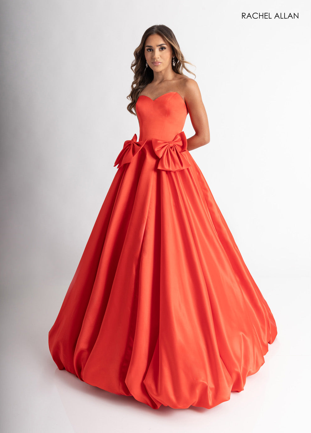 Rachel Allan 71035 Strapless red ballgown with oversized bows and a full skirt, perfect for prom prom dress.